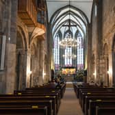 People sit at marked places to keep distance as they take part in a small church service. Picture: Ian Fassbender/AFP via Getty Images