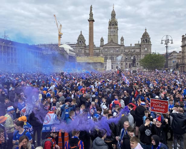 Rangers fans celebrate winning the Scottish Premiership title at George Square