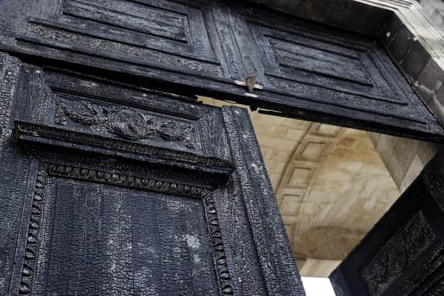 The burnt door of Bordeaux's city hall, is pictured the day after it was set on fire by demonstrators during a rally against pension reform.