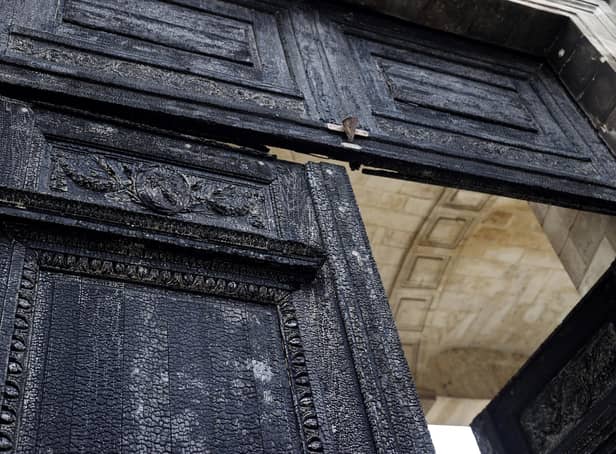 The burnt door of Bordeaux's city hall, is pictured the day after it was set on fire by demonstrators during a rally against pension reform.
