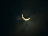 The moon partially covers the sun during an annular solar eclipse as seen from Siliguri on June 21, 2020. (Photo by Diptendu DUTTA / AFP).