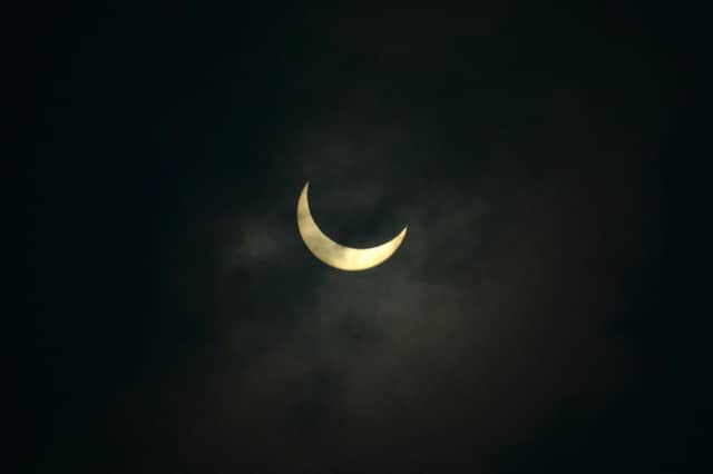 The moon partially covers the sun during an annular solar eclipse as seen from Siliguri on June 21, 2020. (Photo by Diptendu DUTTA / AFP).