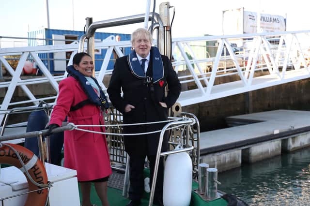 Boris Johnson refused to sack his Home Secretary Priti Patel, seen with the Prime Minister on a security vessel in Southampton port, despite a report concluding she had broken the ministerial code over treatment of civil servants (Picture: Hannah McKay/WPA pool/Getty Images)