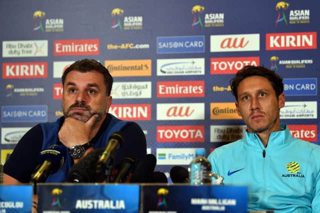 Ange Postecoglou, left, and Mark Milligan speak at an Australia press conference in 2017
