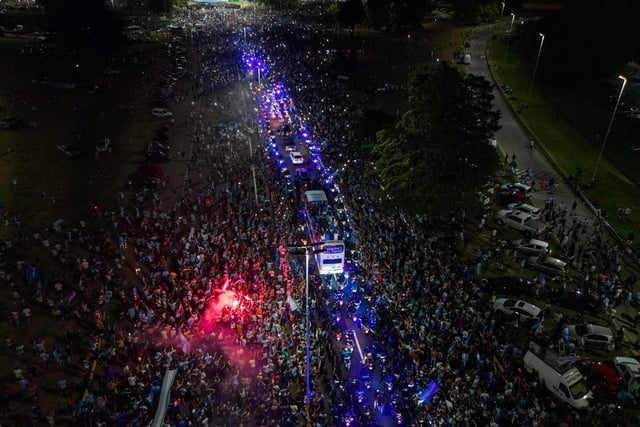 This aerial image shows Argentina's players celebrating on board a bus with supporters  (Photo by Tomas CUESTA / AFP) (Photo by TOMAS CUESTA/AFP via Getty Images)