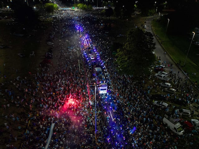 This aerial image shows Argentina's players celebrating on board a bus with supporters (Photo by Tomas CUESTA / AFP) (Photo by TOMAS CUESTA/AFP via Getty Images)
