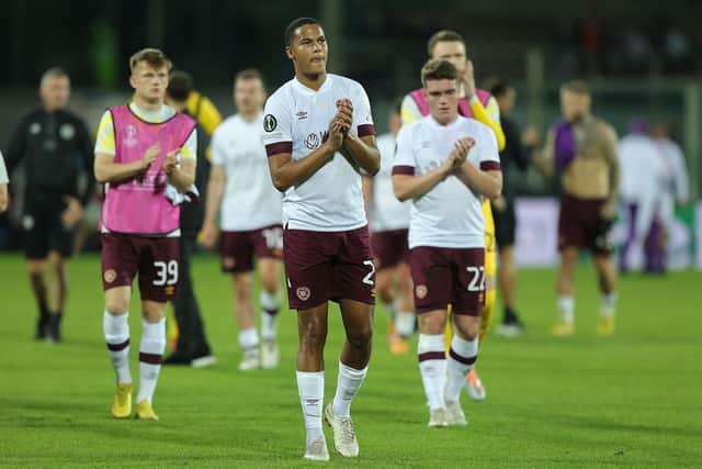 The Hearts players applaud the travelling fans at full time.