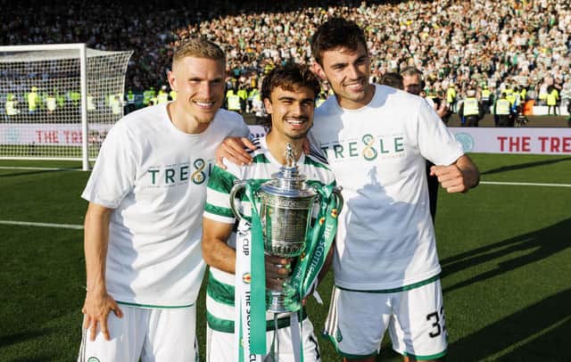 Celtic's Carl Starfelt (L) Jota and Matt O'Riley (R) with the Scottish Cup last season.
