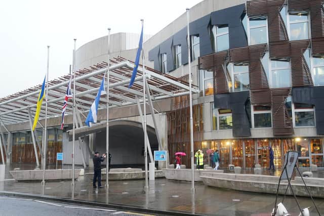 Flags being lowered to half mast outside The Scottish Parliament building at Holyrood in Edinburgh following the announcement of the death of Queen Elizabeth II.
