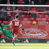 Joe Lewis is beaten by Joseph Hungbo's penalty as Aberdeen lost to Ross County.