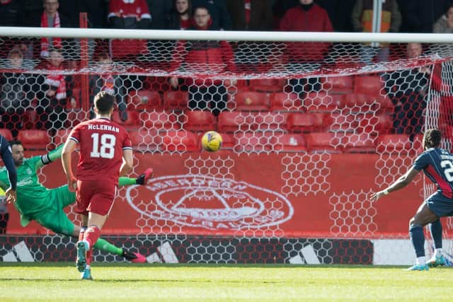 Joe Lewis is beaten by Joseph Hungbo's penalty as Aberdeen lost to Ross County.