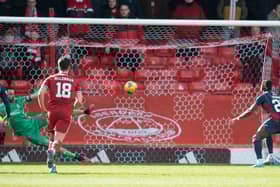 Joe Lewis is beaten by Joseph Hungbo's penalty as Aberdeen lost to Ross County.