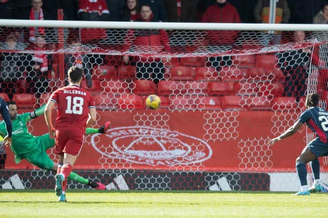 Joe Lewis is beaten by Joseph Hungbo's penalty as Aberdeen lost to Ross County.