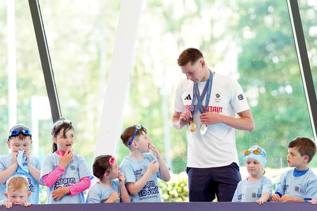 Duncan Scott shows his Olympic medals to children at the Peak Leisure Centre in Stirling, highlighting the importance of community facilities that provide kids from all backgrounds vital life skills. (Picture: Jane Barlow/PA Images)