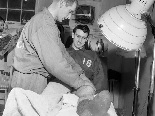 Eric Stevenson is pictured receiving treatment from Hibs trainer Tom McNiven at Easter Road in January 1964.