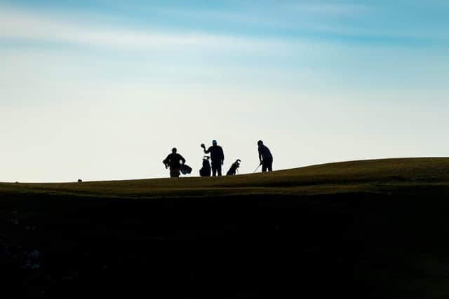 Golfers play a round at North Berwick West Links in late March