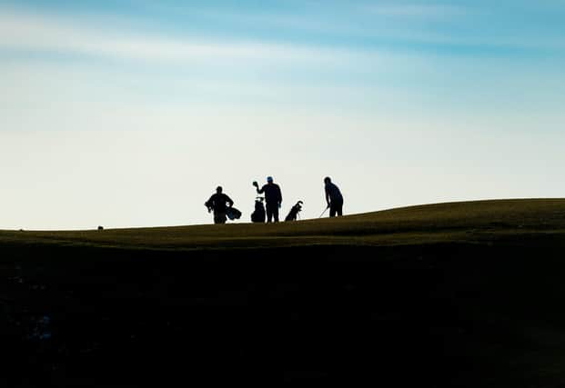 Golfers play a round at North Berwick West Links in late March