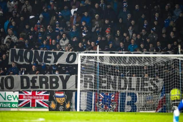 Rangers fans show a banner against the friendly in Australia during a Cinch Premiership match between St Johnstone and Rangers at McDiarmid Park, Perth.  (Photo by Rob Casey / SNS Group)