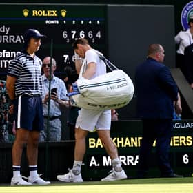 Andy Murray trudges off after his five-set defeat by Stefanos Tsitsipas at Wimbledon.