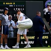 Andy Murray trudges off after his five-set defeat by Stefanos Tsitsipas at Wimbledon.