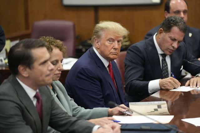 Former U.S. President Donald Trump sits at the defense table in a Manhattan court during his arraignment on April 4, 2023, in New York City. . (Photo by Seth Wenig-Pool/Getty Images)