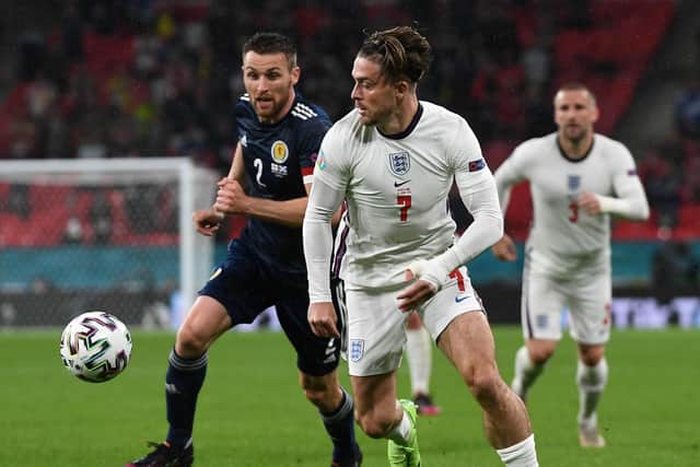 Scotland's Stephen O'Donnell vying for the ball with England's Jack Grealish during their sides' UEFA Euro 2020 Championship group D match at London's Wembley Stadium