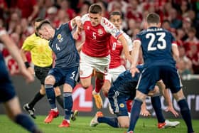 Denmark's Joakim Mahle (C) and Scotland's Billy Gilmour (L) vie for the ball during the 2022 FIFA World Cup qualifier group F football match between Denmark and Scotland at Parken Stadium in Copenhagen on September 1, 2021. (Photo by MADS CLAUS RASMUSSEN/Ritzau Scanpix/AFP via Getty Images)