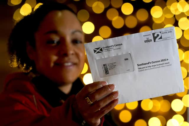 Postal worker Patrona Tunilla holds a sample Scotland's Census letter during its launch at the University of Glasgow (Picture: Andrew Milligan/PA)