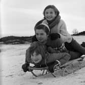 Three girls sledging on the Braid Hills in 1964.