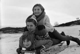 Three girls sledging on the Braid Hills in 1964.