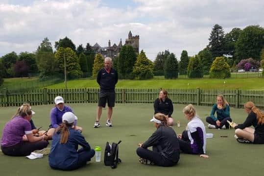 Dean Robertson, Stirling University's high performance golf coach, talks to a group of potential scholars at the campus.