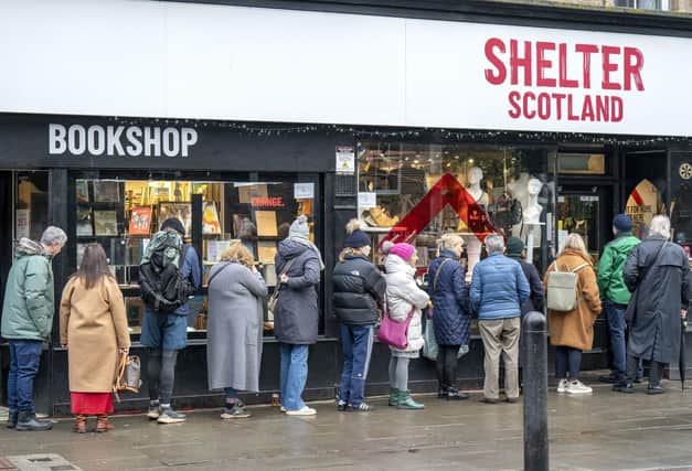 Customers queue outside the Shelter Scotland charity shop in Edinburgh's Stockbridge. Photo: Jane Barlow/PA Wire