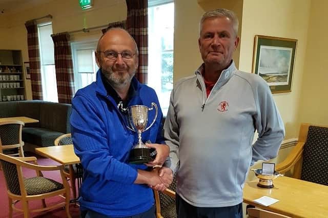 Ratho Park's Dave Campbell, left, is presented with the Lothians Seniors' trophy by LGA president Neil Anderson at Kilspindie.