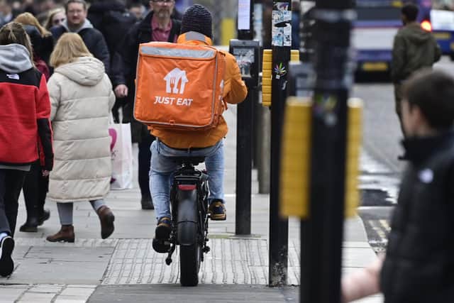 A delivery rider on a pavement in Glasgow city centre on Friday (Photo by John Devlin/The Scotsman)
