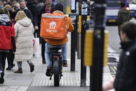 A delivery rider on a pavement in Glasgow city centre on Friday (Photo by John Devlin/The Scotsman)
