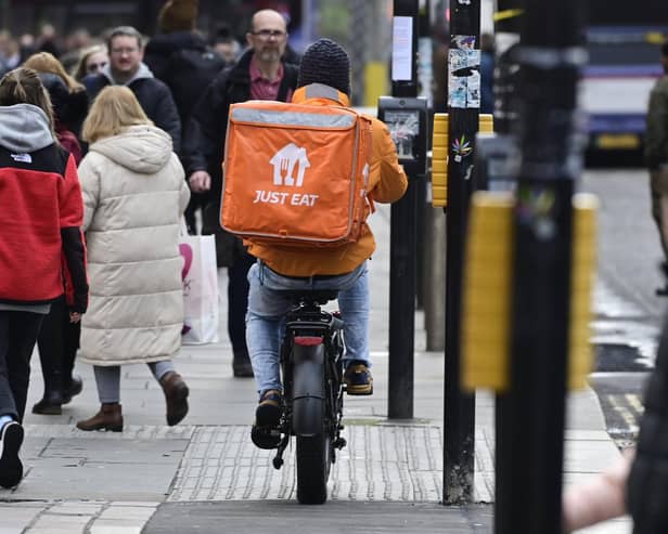 A delivery rider on a pavement in Glasgow city centre on Friday (Photo by John Devlin/The Scotsman)