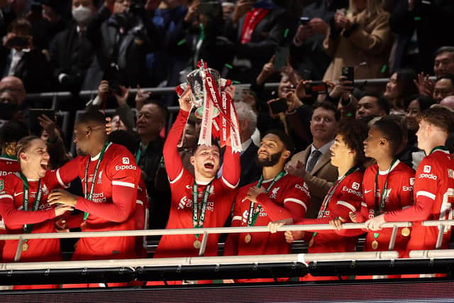 Andy Robertson, centre, lifts the Carabao Cup after Liverpool overcame Chelsea at Wembley.