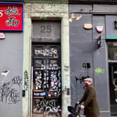 Where it all began: 25 Clerk Street, where the graffiti on the front door gives way to a people's history played out at the address which is rich in triumph and loss. PIC: Diarmid Mogg.
