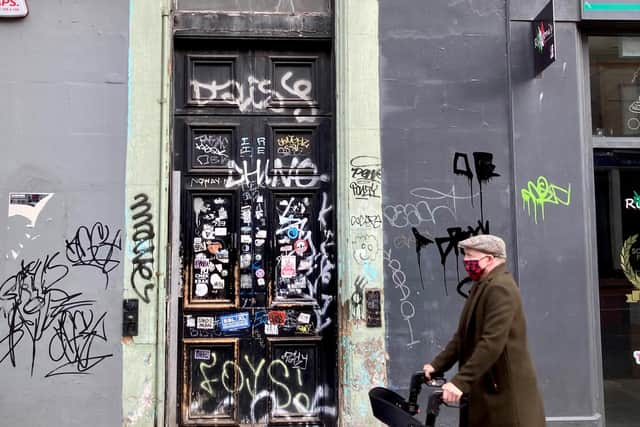 Where it all began: 25 Clerk Street, where the graffiti on the front door gives way to a people's history played out at the address which is rich in triumph and loss. PIC: Diarmid Mogg.