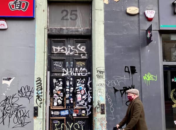 Where it all began: 25 Clerk Street, where the graffiti on the front door gives way to a people's history played out at the address which is rich in triumph and loss. PIC: Diarmid Mogg.