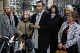 Solicitor Aamer Anwar and members of Scottish Covid Bereaved read a statement outside the UK Covid inquiry. Picture: Jeff J Mitchell/Getty Images