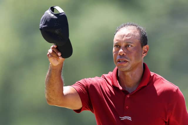 At the end of his 100th round at The Masters, five-time winner Tiger Woods waves his hat to the crowd. Picture: Andrew Redington/Getty Images.
