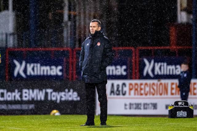 Aberdeen manager Stephen Glass cuts a solemn figure during the 2-1 defeat to Dundee at Dens Park.