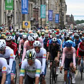 Riders cycle down the Royal Mile at the start of the men's Elite Road Race at the Cycling World Championships in Edinburgh (Photo by Oli SCARFF / AFP)