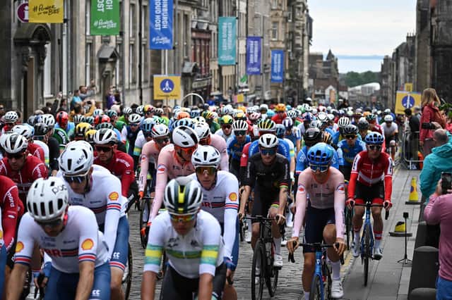 Riders cycle down the Royal Mile at the start of the men's Elite Road Race at the Cycling World Championships in Edinburgh (Photo by Oli SCARFF / AFP)