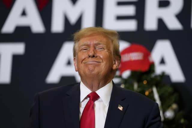 Former President Donald Trump reacts to supporters during a commit to caucus rally. Picture: AP Photo/Charlie Neibergall