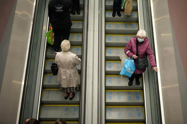 People wear face masks in Warrington town centre as the borough enters Covid-19 Tier 3 'Very High' lockdown restrictions. Picture: Christopher Furlong/Getty Images