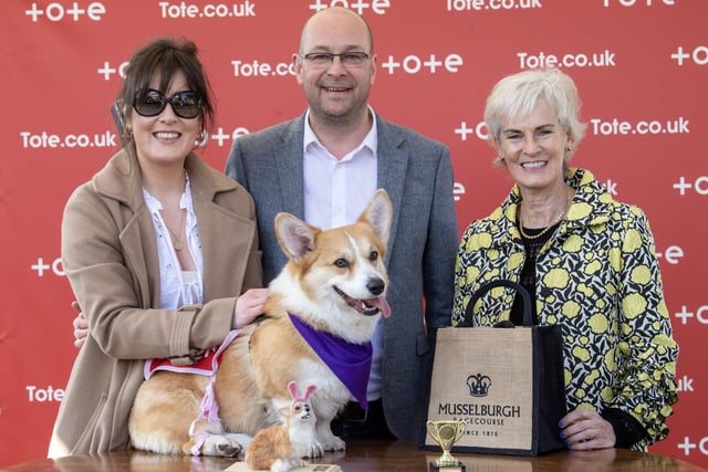 Winner of the Corgi Derby Rodney alongside his owners Matt Kendall and Nicole Whiteside is presented a trophy from Judy Murray.