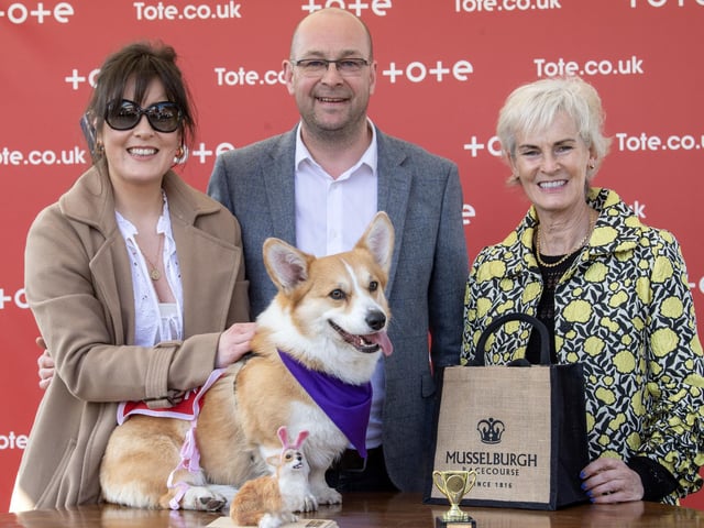 Winner of the Corgi Derby Rodney alongside his owners Matt Kendall and Nicole Whiteside is presented a trophy from Judy Murray.