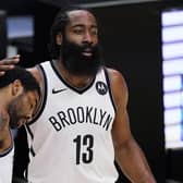 Brooklyn Nets guard Kyrie Irving, left, gets a pat on the head from guard James Harden. Picture: Mark J. Terrill/AP